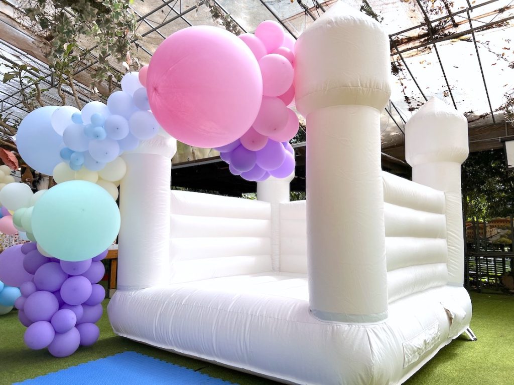 White Bouncy Castle with Organic Balloon Decor