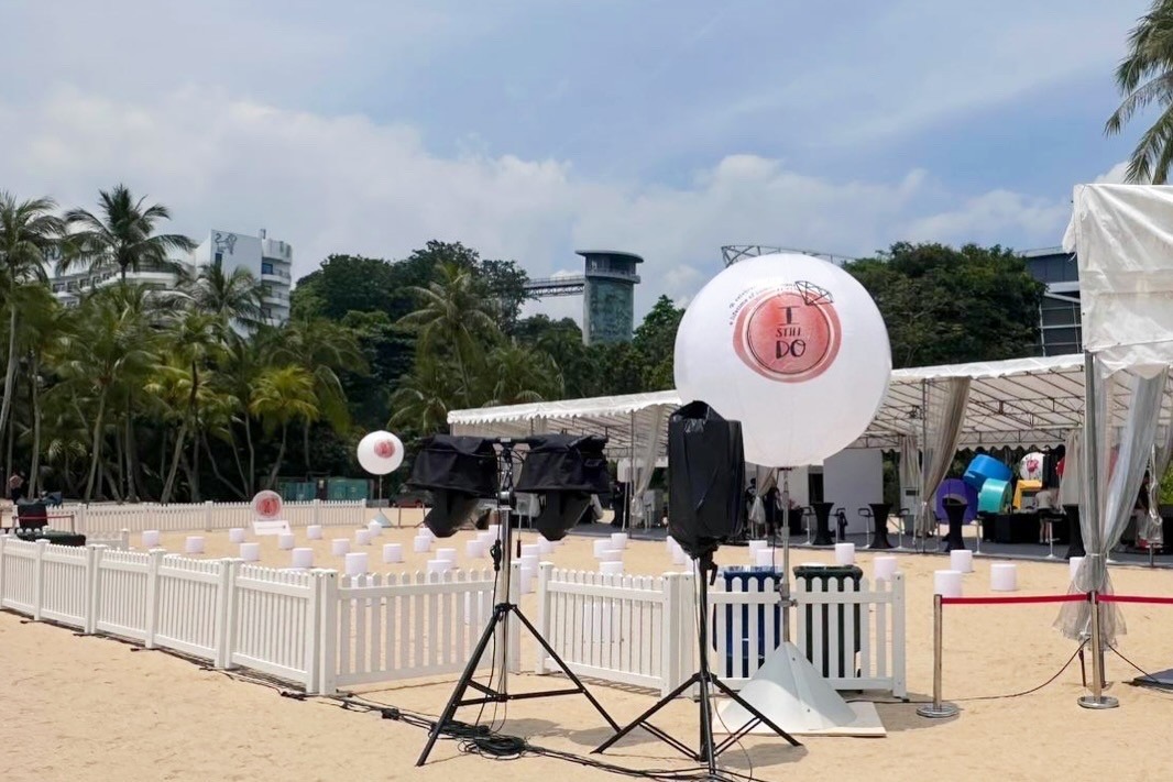 Branded advertising balloon setup at a beach corporate event in Singapore