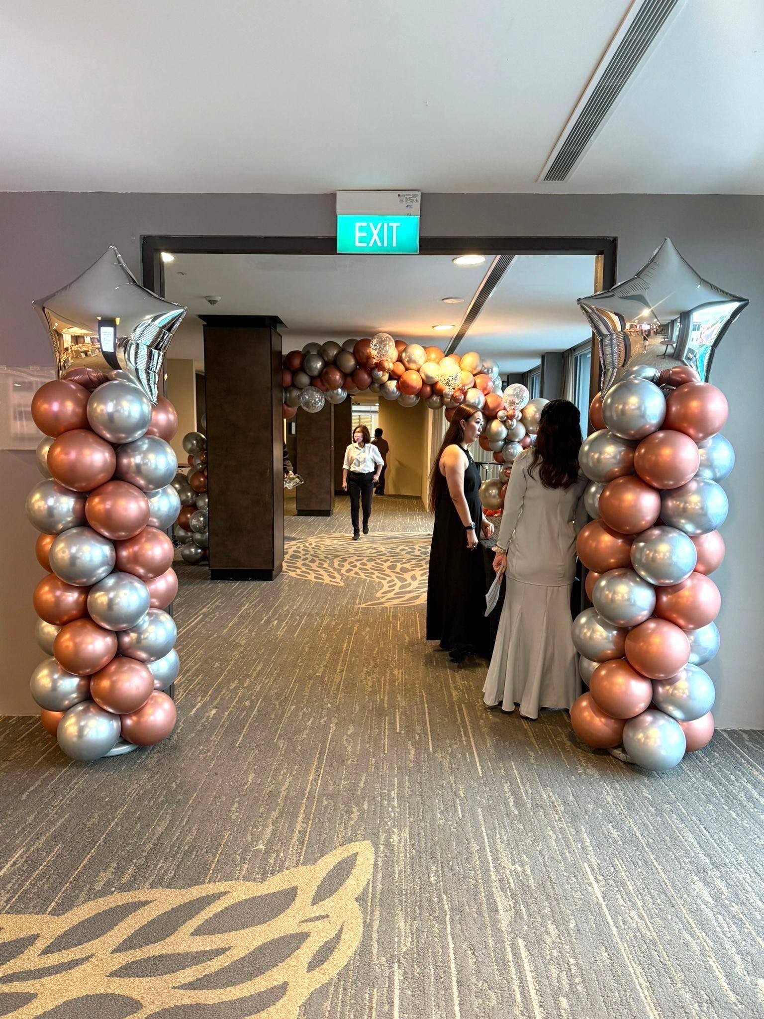 Chrome rose gold balloon columns and organic arch corporate balloon decorations Singapore