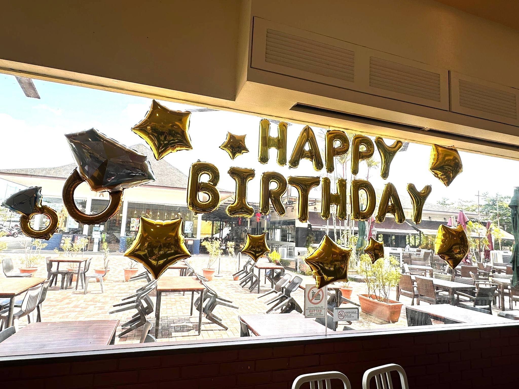 Gold Happy Birthday foil Helium Balloons Singapore at a restaurant celebration