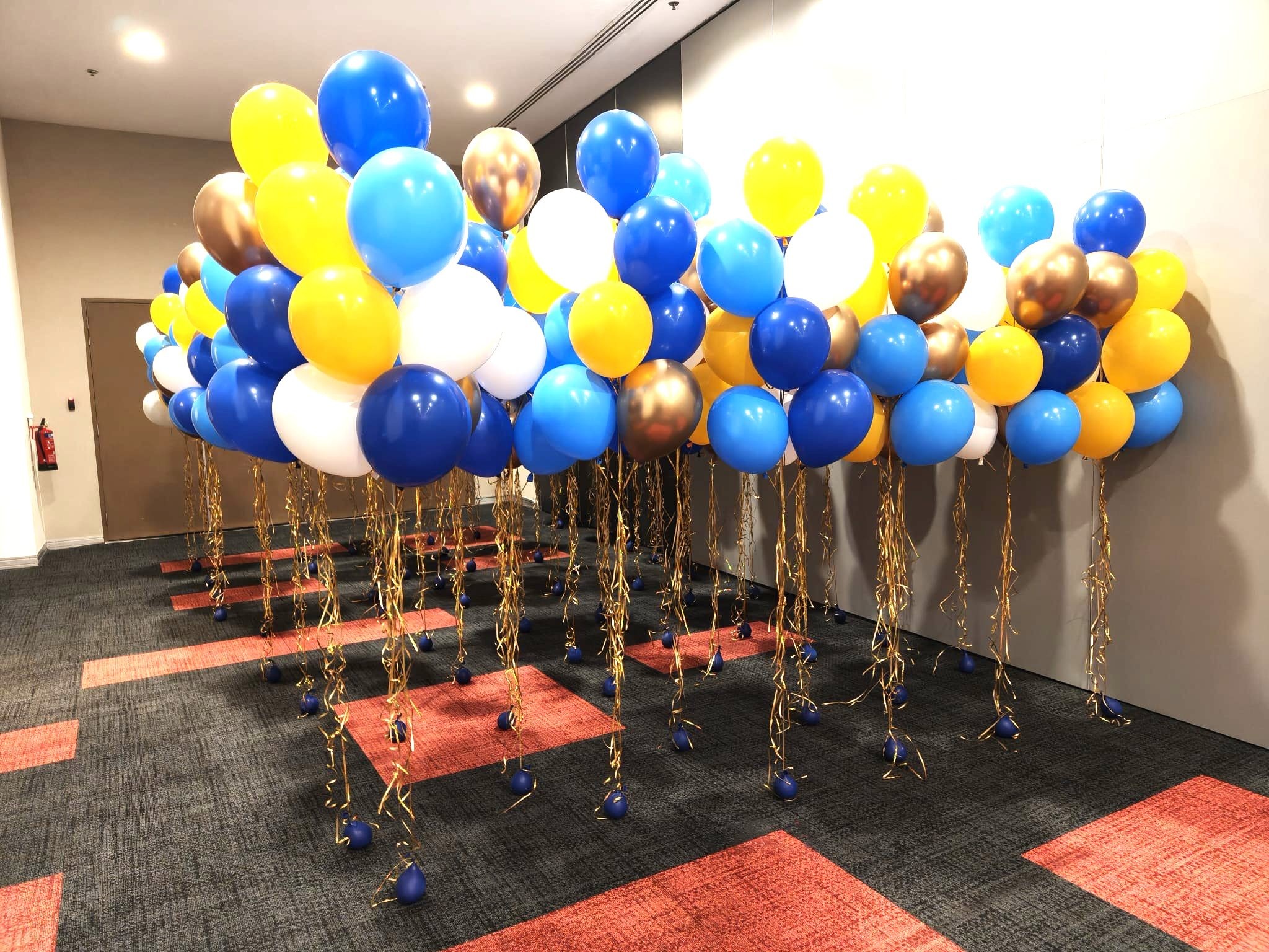 Helium Balloons Singapore clusters with gold streamers at a corporate event
