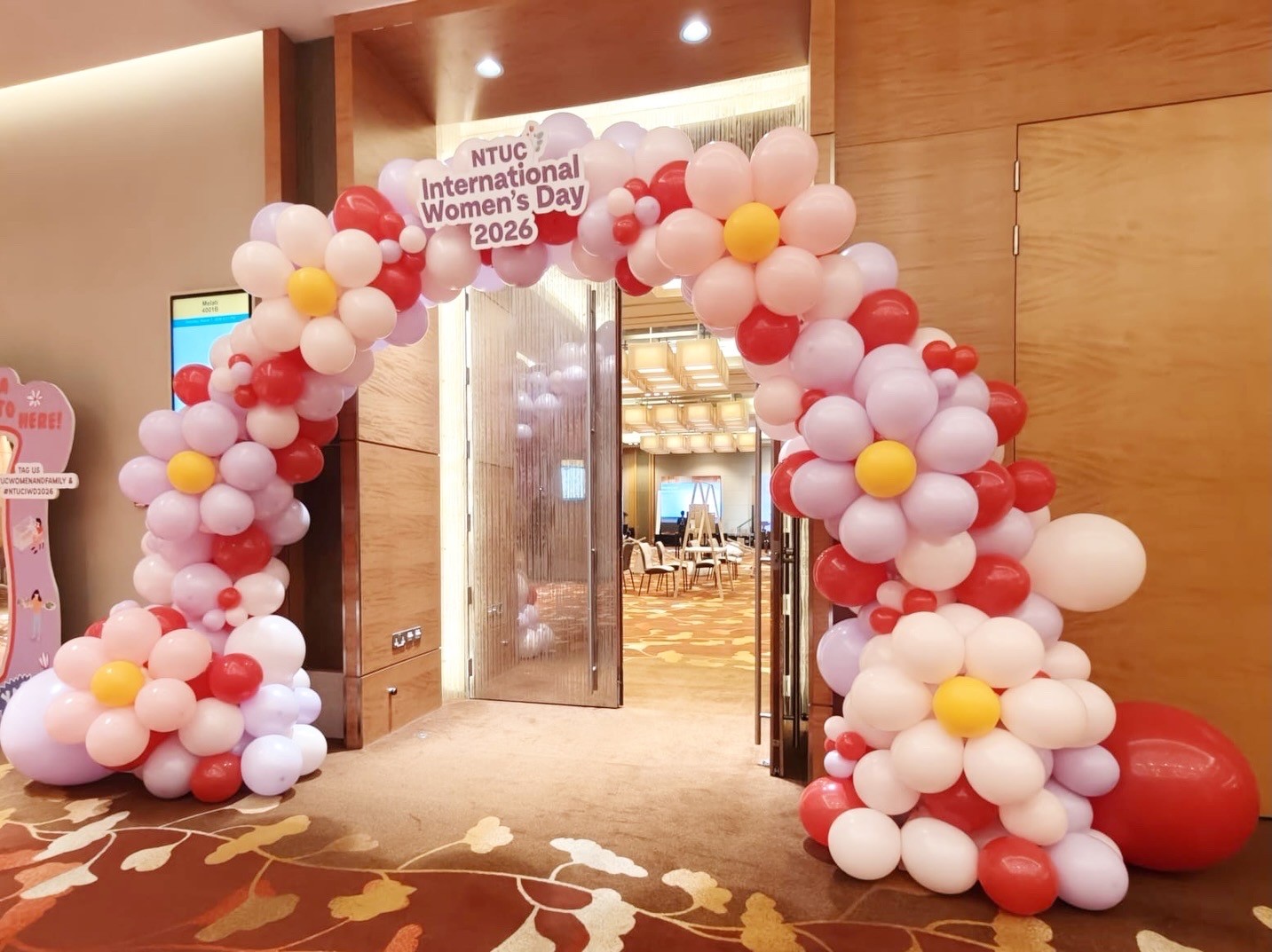 Organic arch with florals Balloon Decorations Singapore at corporate event entrance