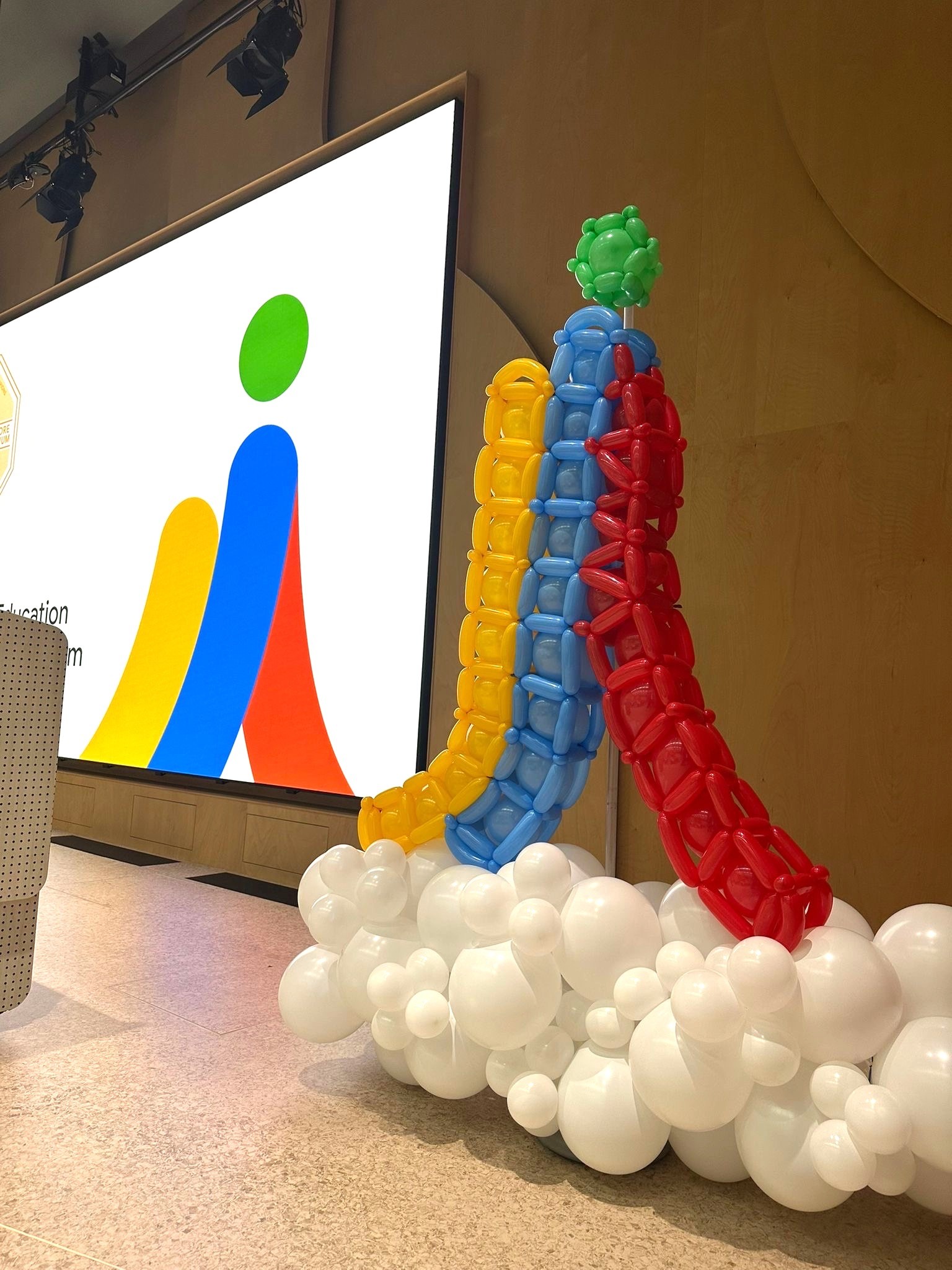 Custom branded balloon sculpture for corporate stage decoration in Singapore