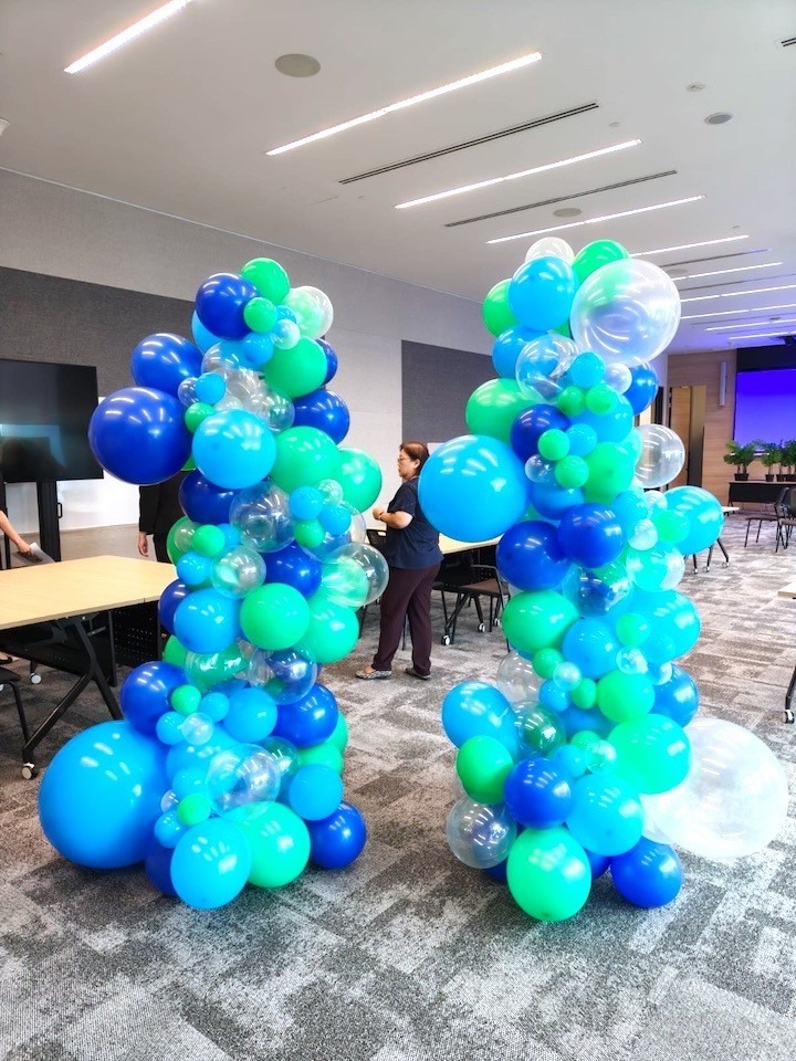 Blue and green organic balloon columns for corporate event in Singapore