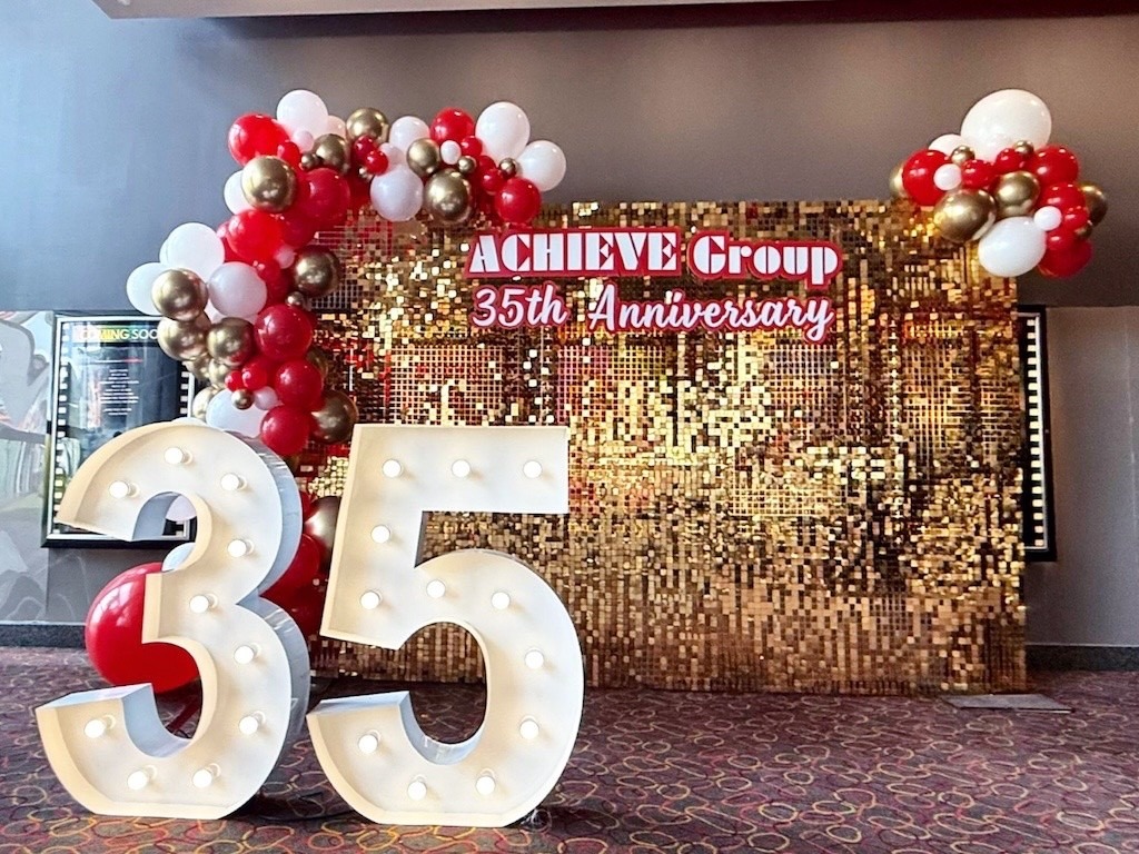 Gold sequin backdrop with organic balloon garland for corporate anniversary in Singapore