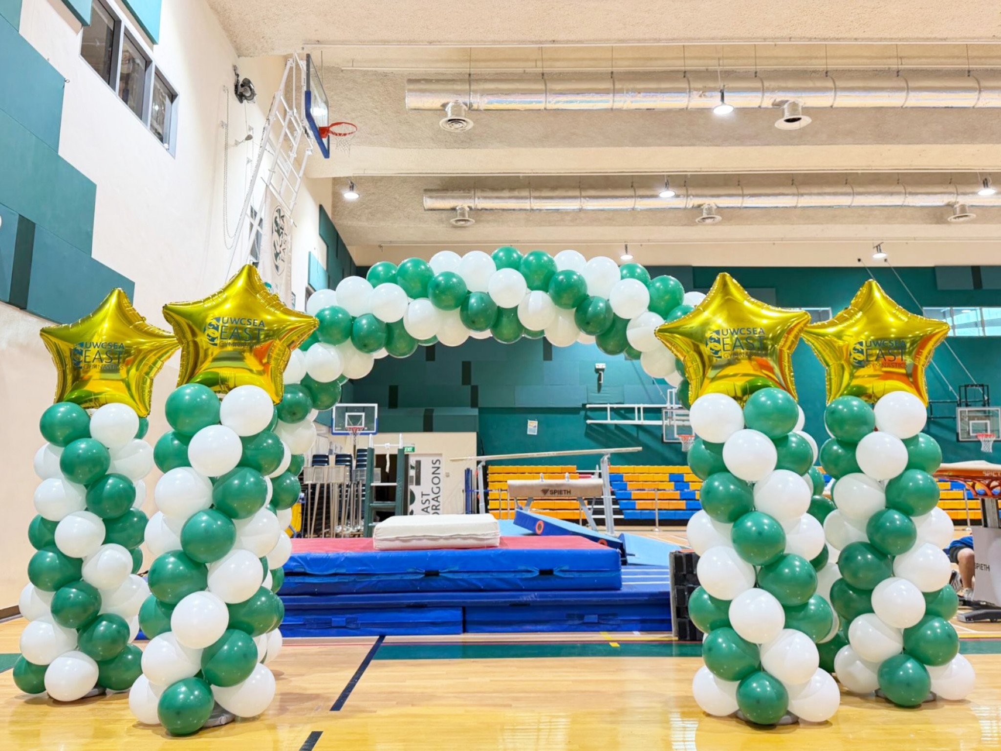Balloon arch and columns with gold stars for school event Singapore