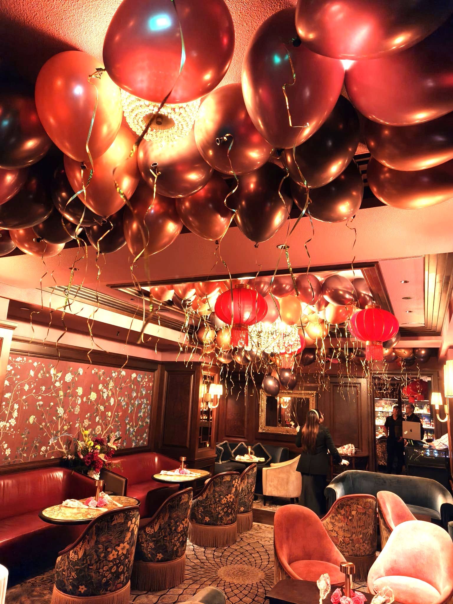 Helium Balloons Singapore: Complete 2026 Guide to Prices, Packages & Delivery 5 Red and gold helium balloon ceiling decoration at a lounge event in Singapore