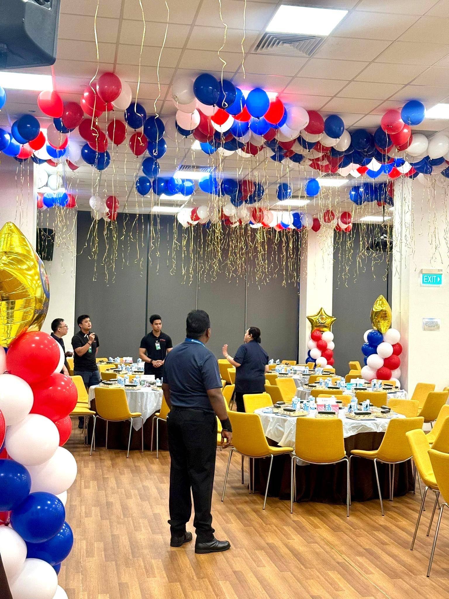 Helium Balloons Singapore: Complete 2026 Guide to Prices, Packages & Delivery 3 Red white and blue helium balloon ceiling installation at a corporate dinner in Singapore