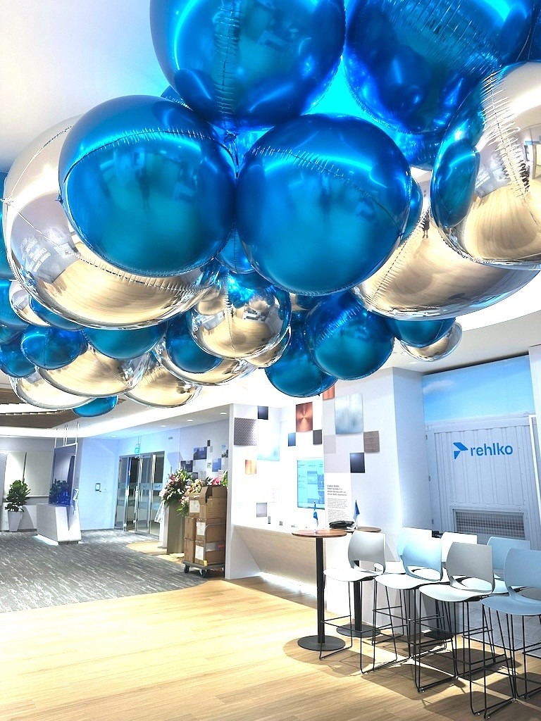Blue and silver foil helium balloon ceiling decor at a corporate event in Singapore