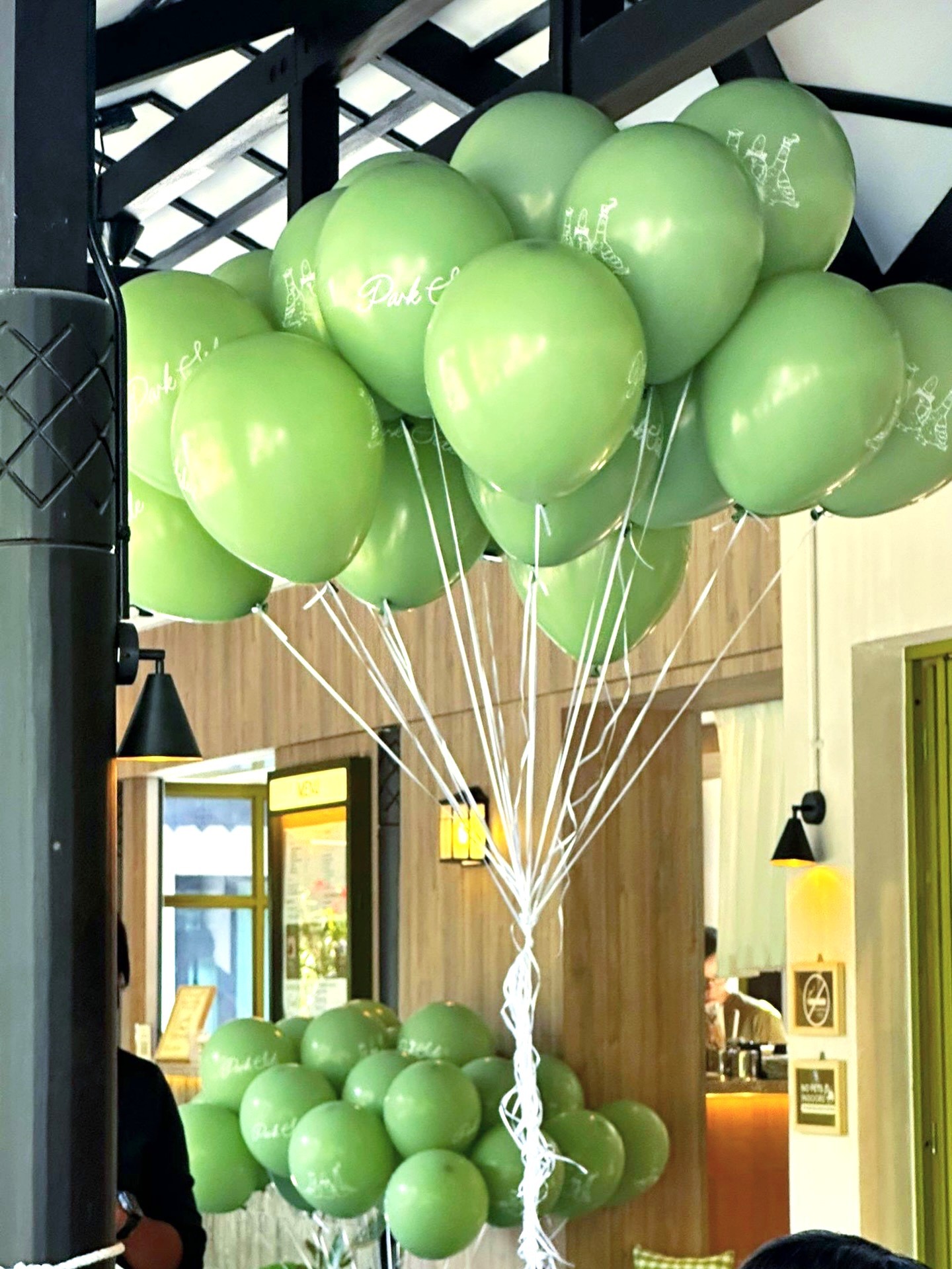 Custom printed green helium balloons for event decoration Singapore