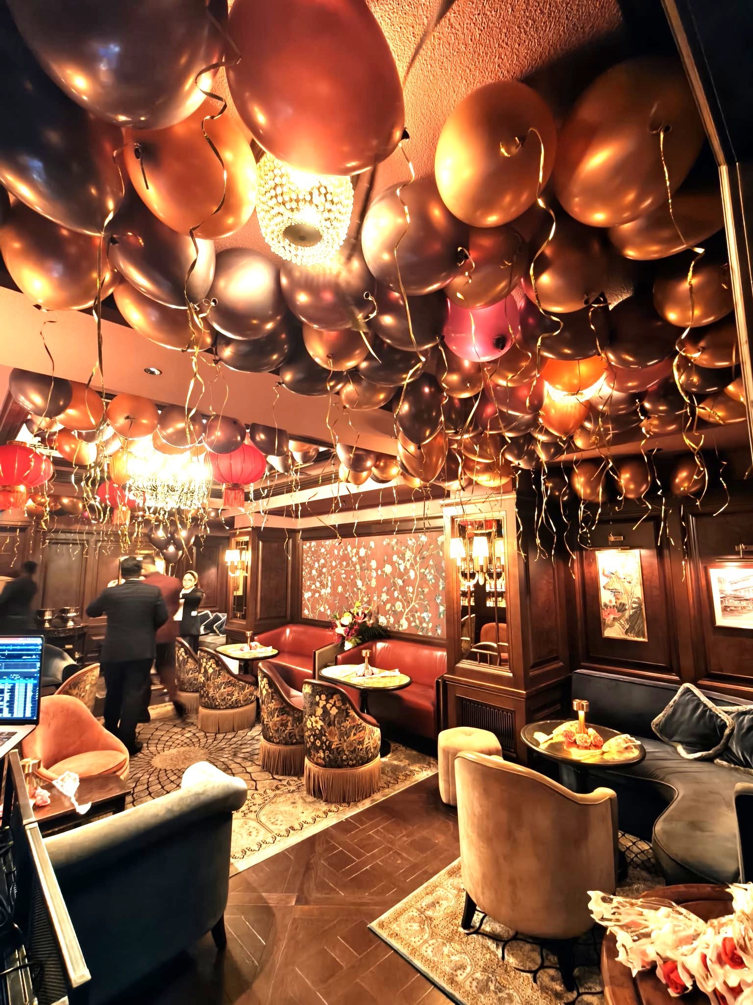 Gold and black helium balloon ceiling at lounge party Singapore