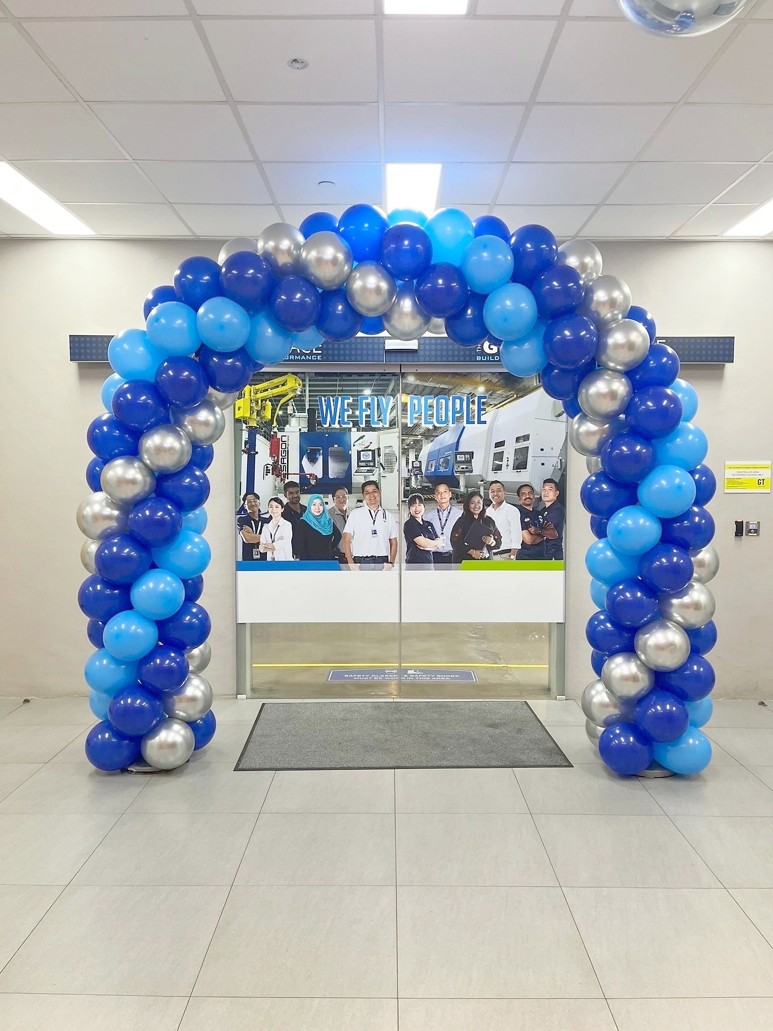 Blue and silver balloon arch around double doors