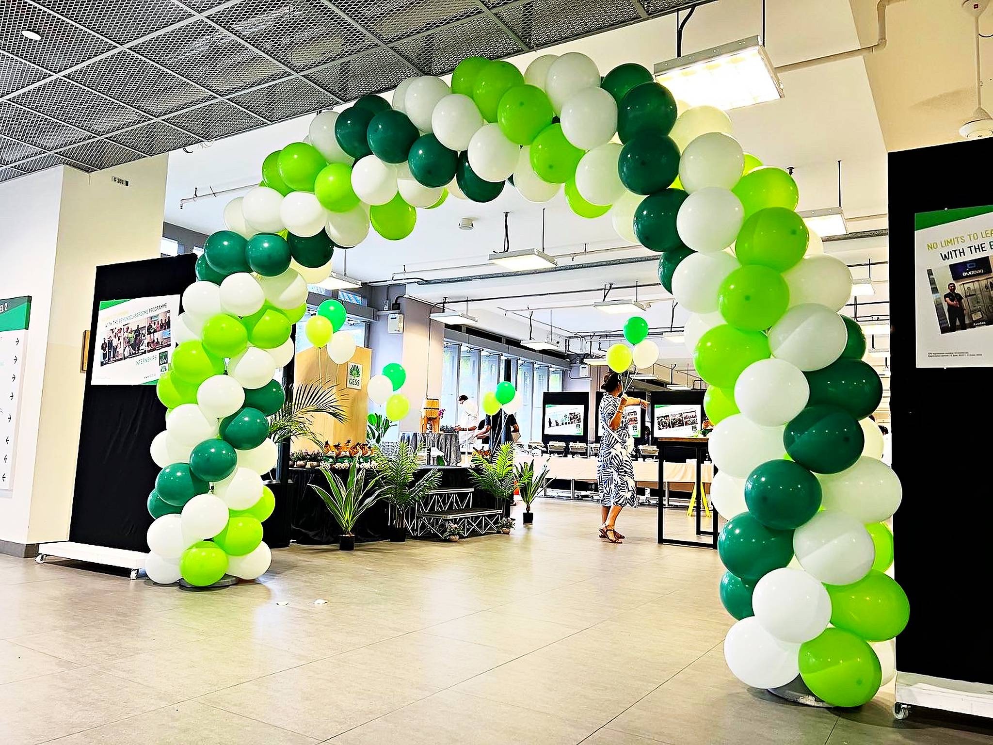 Green lime and white balloon arch in a school hall