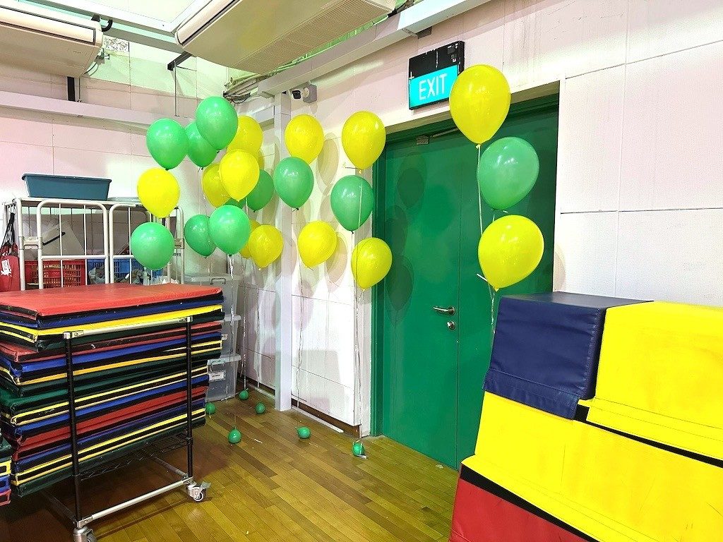 Green yellow helium balloon clusters school event Singapore