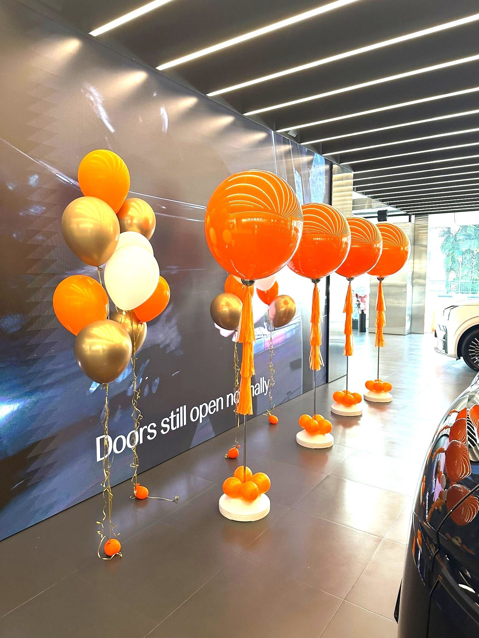 Orange gold helium balloon stands car showroom corporate event Singapore