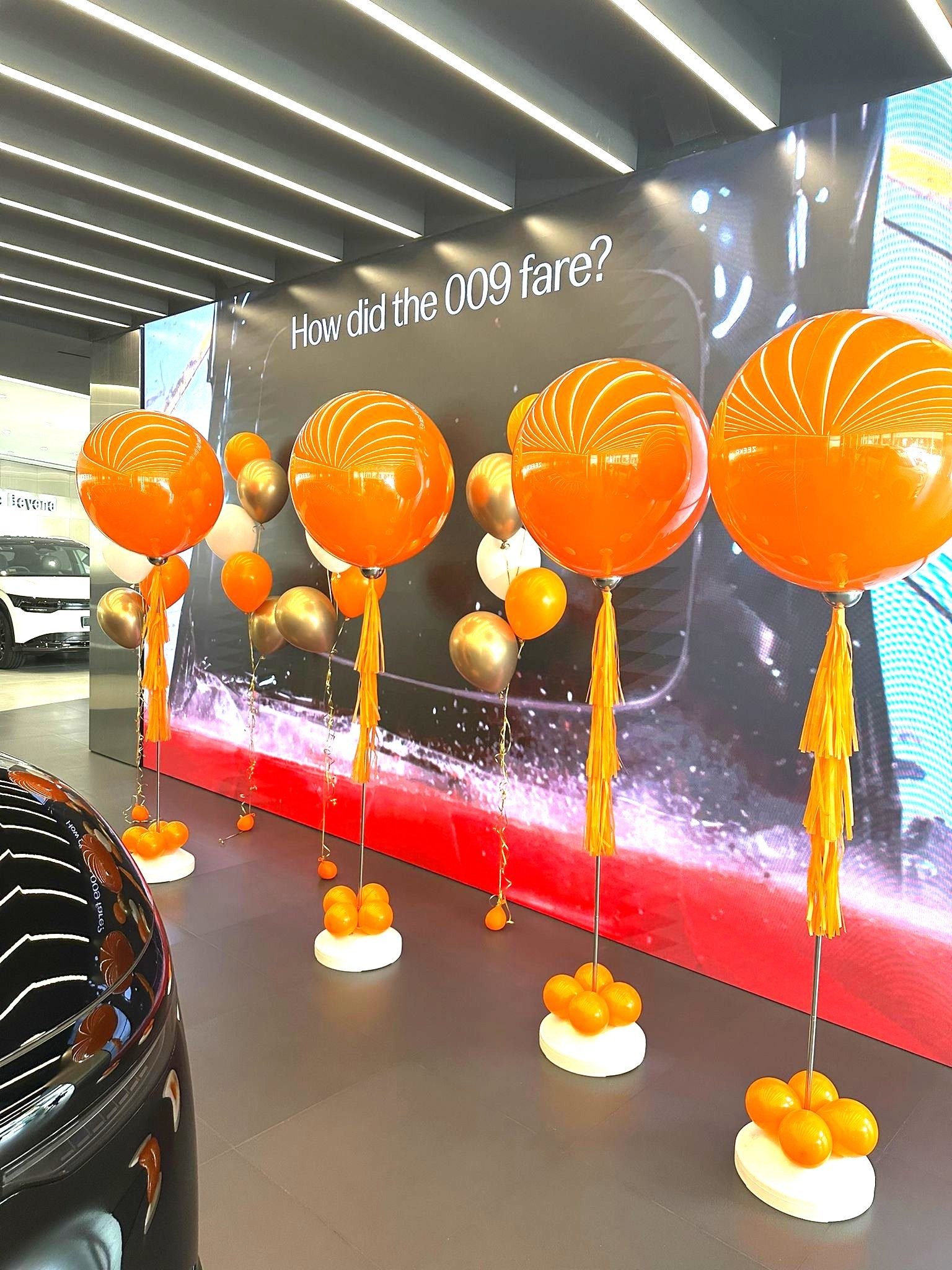 Orange helium balloon stands car showroom launch event Singapore