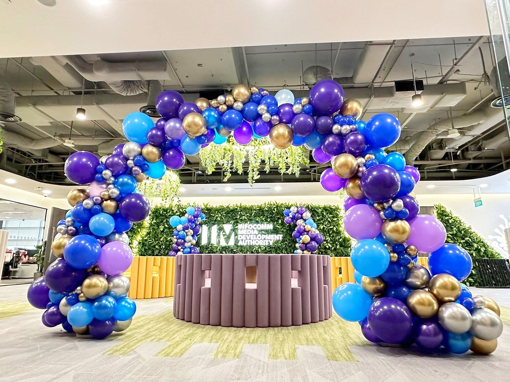 Balloon Arch in blue purple and gold at a corporate reception