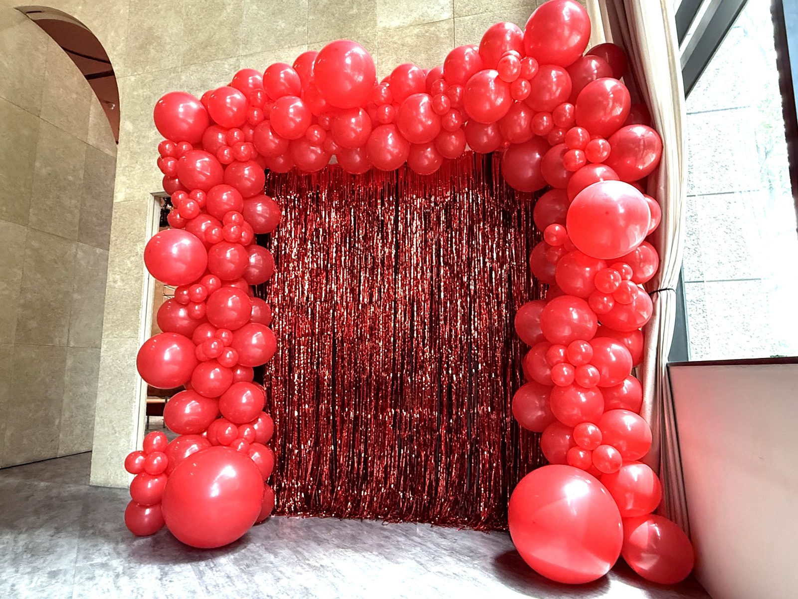 Red organic balloon arch shimmer backdrop event Singapore