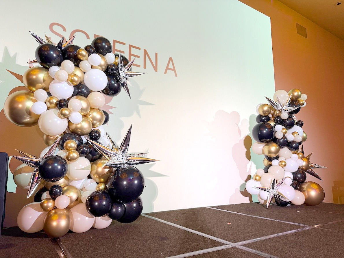 Black gold and pale pink balloon pillars with starburst accents