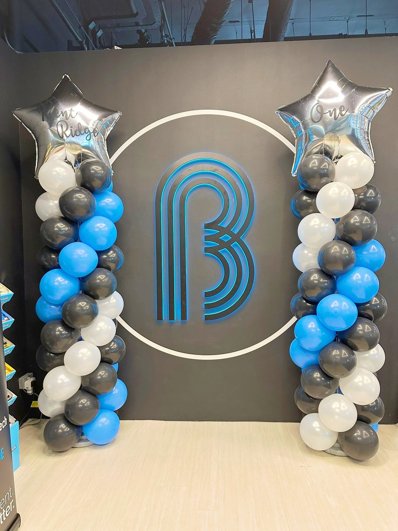 Blue black and white spiral balloon pillars with silver star toppers