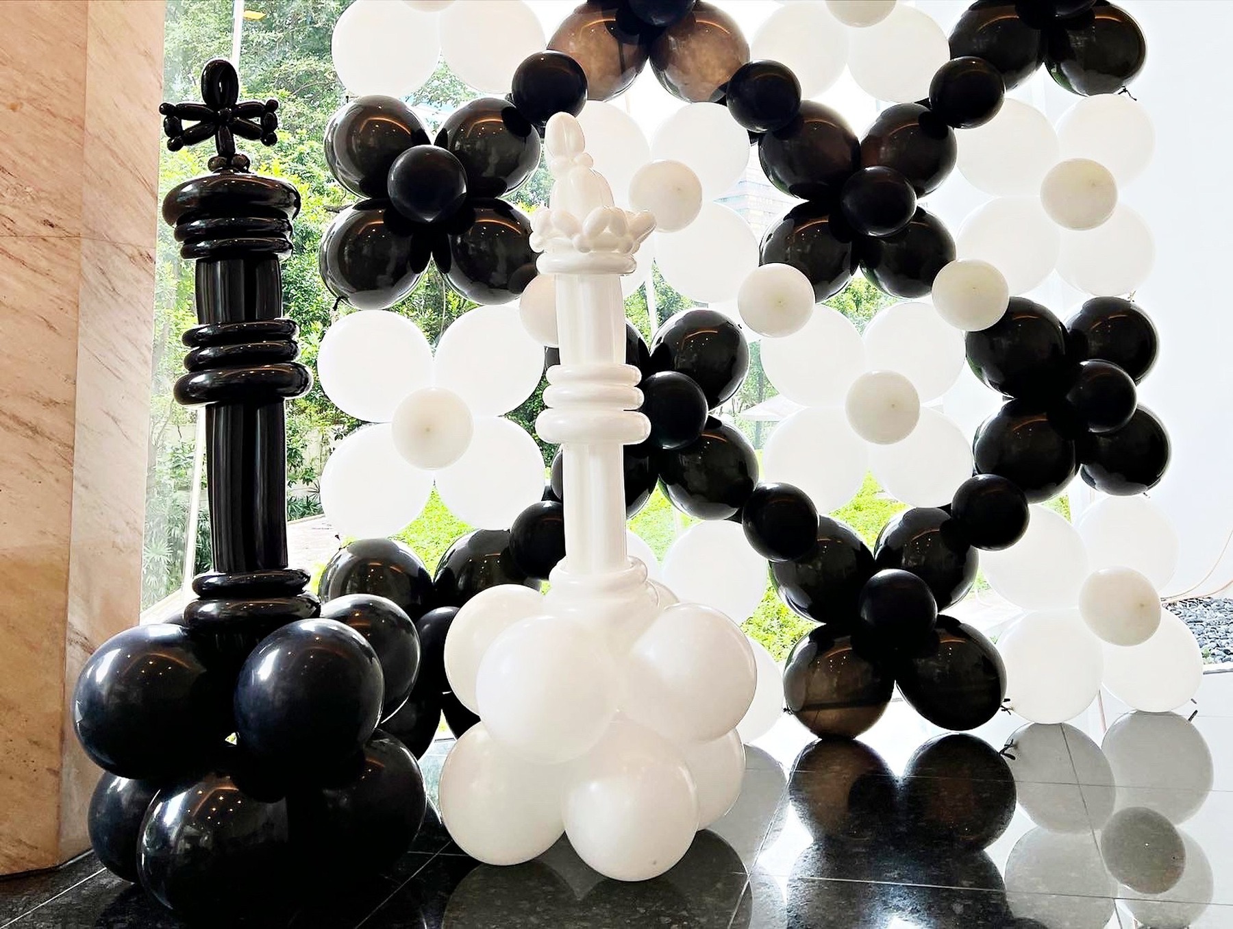 Black and white chess themed balloon wall