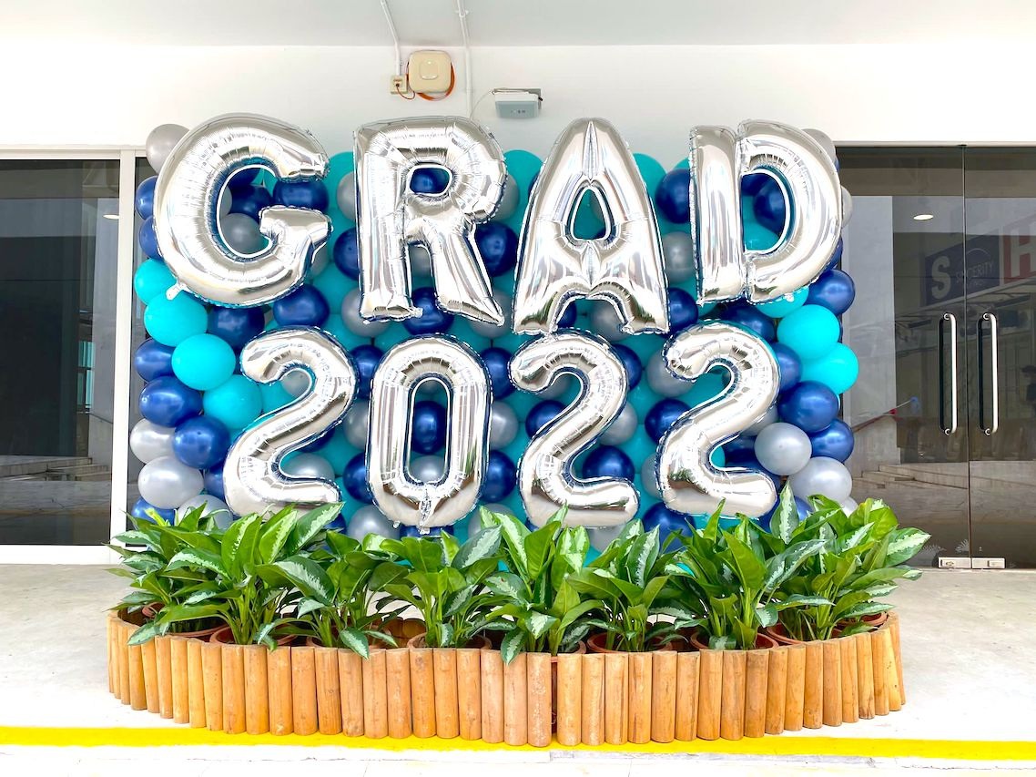 Blue graduation balloon backdrop with silver lettering