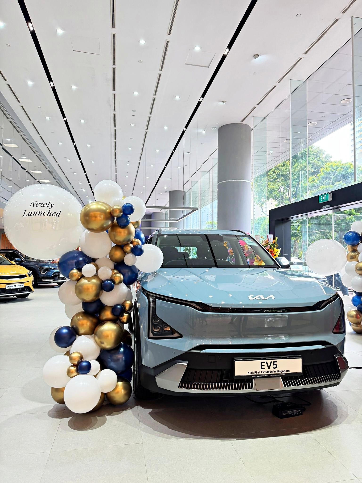 Navy gold and white balloon cluster at a car showroom