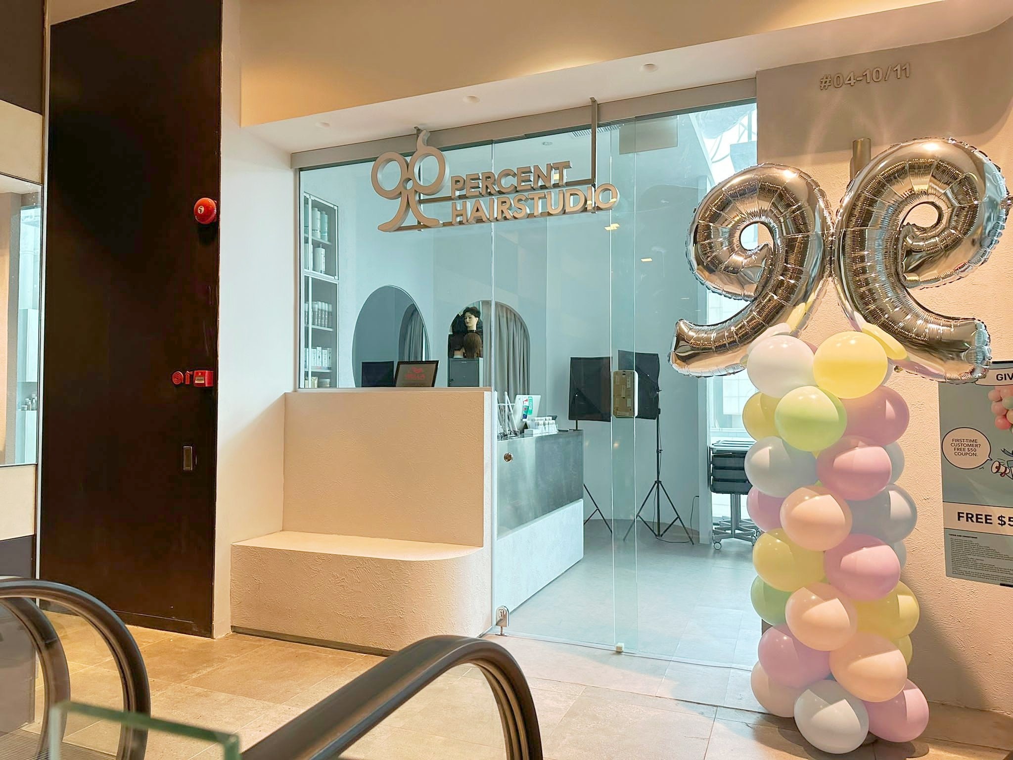Pastel pink yellow mint and lilac balloons with silver scissors at a salon