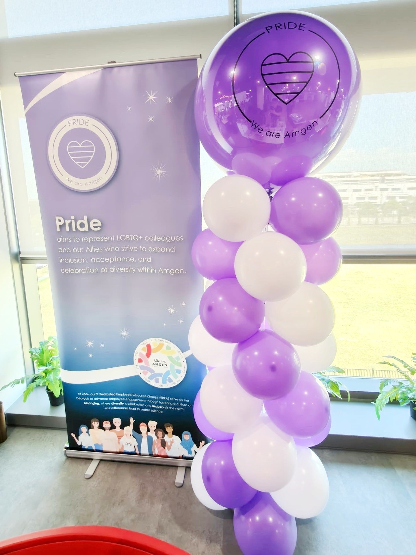 Purple and white balloon column beside a matching corporate banner